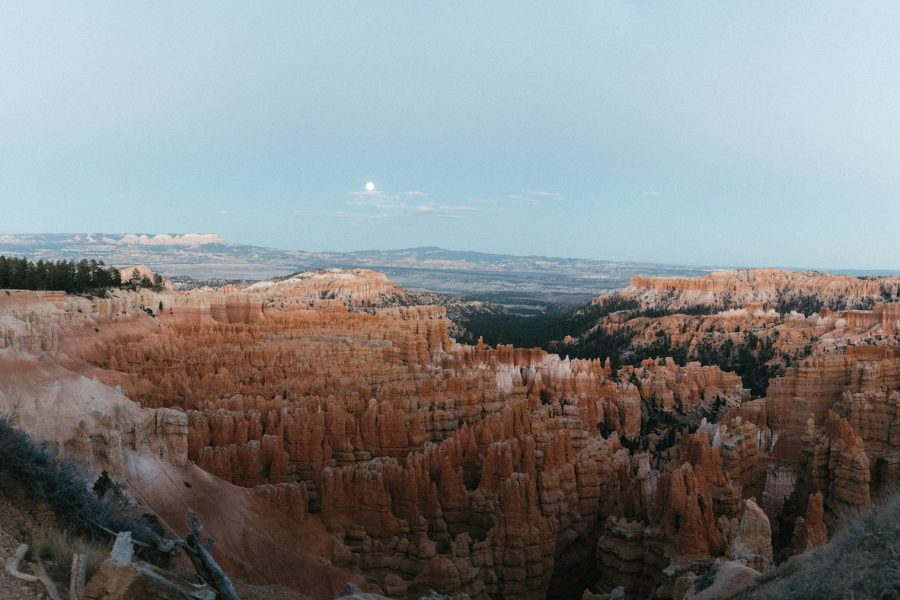 Moon rising over the orange hoodoos of Bryce Canyon National Park at dusk
