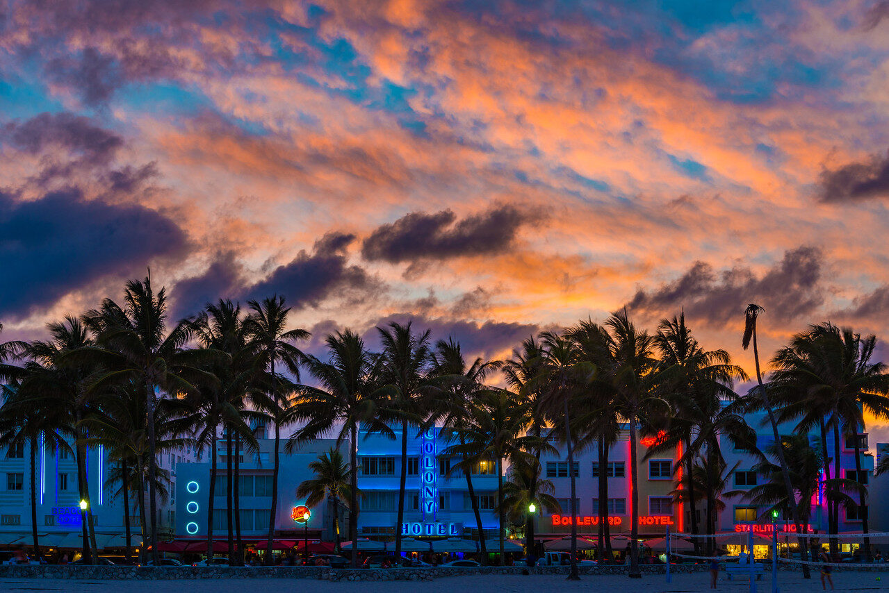 Ocean Drive Miami Beach Art Deco hotels and palms beneath a fiery evening sky