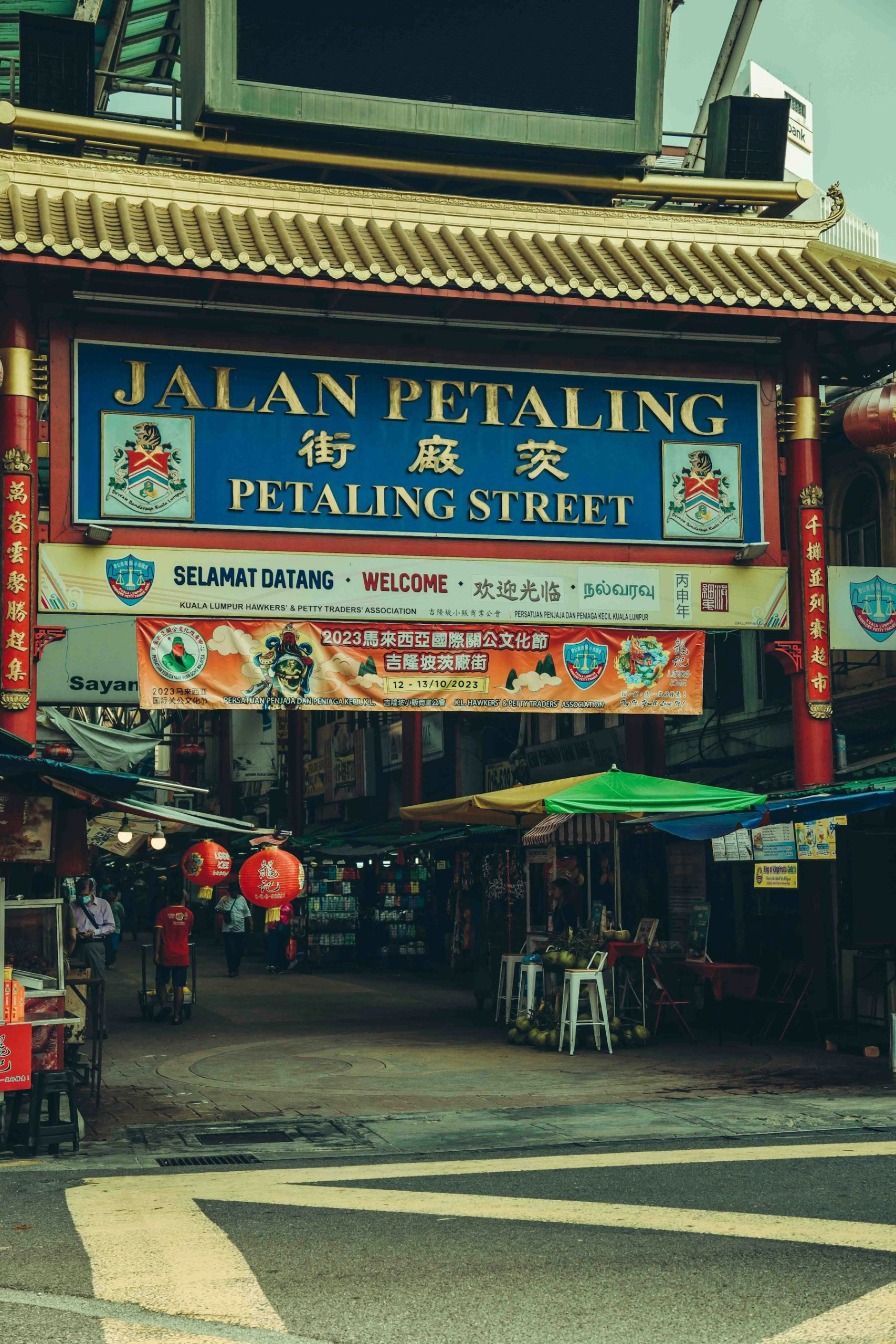 Jalan Petaling entrance sign above market stalls and lanterns.