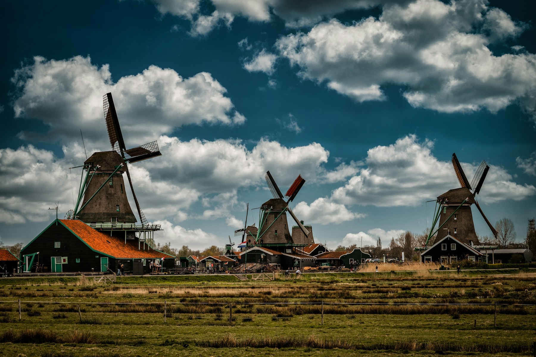Three windmills at Zaanse Schans under dramatic clouds