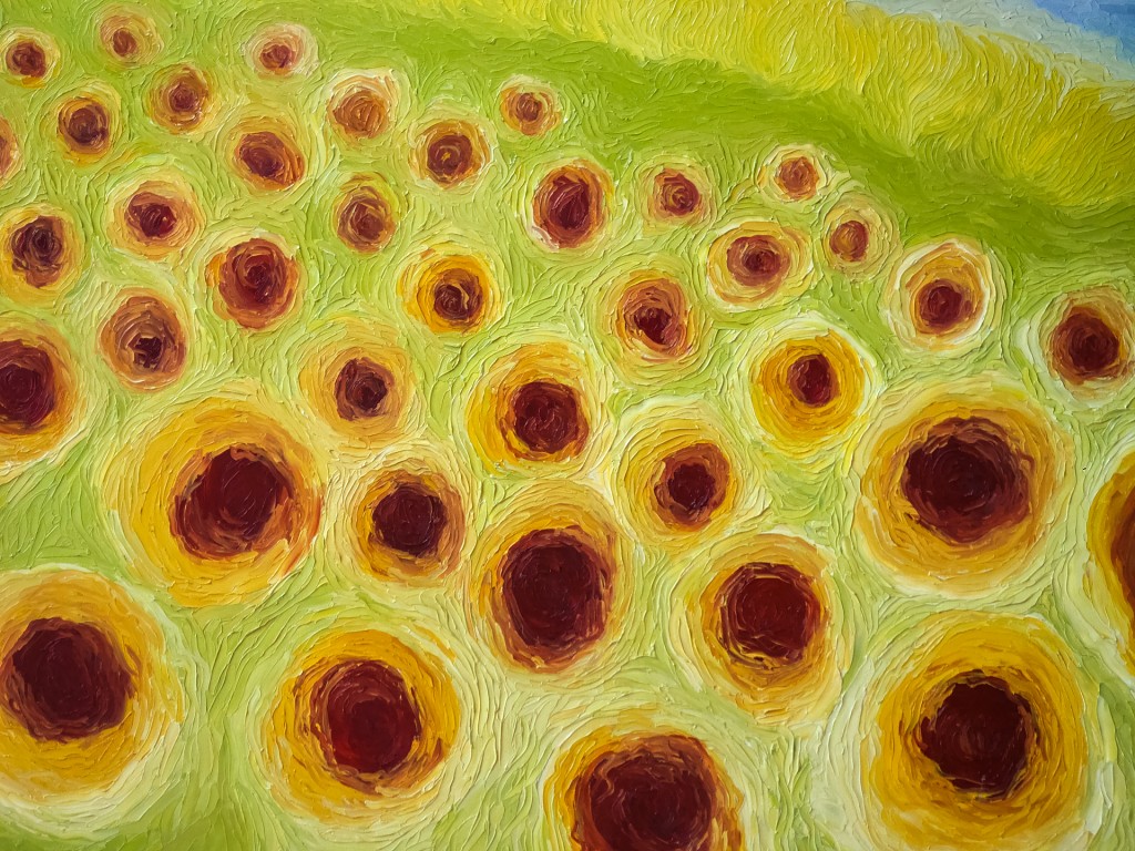 Close view of yellow and orange sunflower painting.