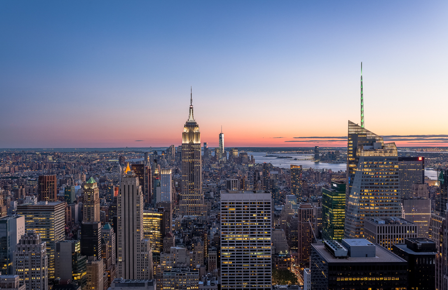 Manhattan skyline at dusk with the Empire State Building near the center.