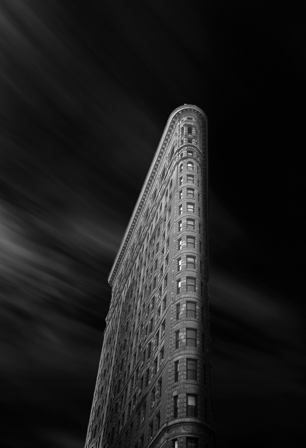 Black-and-white upward view of the Flatiron Building.