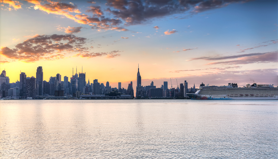 Manhattan skyline seen across the river at sunset.