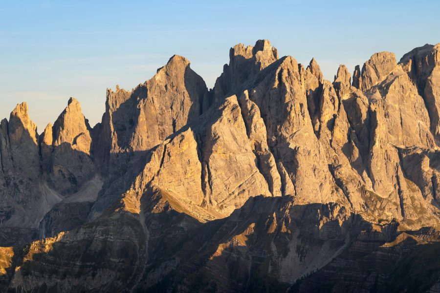 Jagged Dolomites peaks lit gold at sunset, Italy