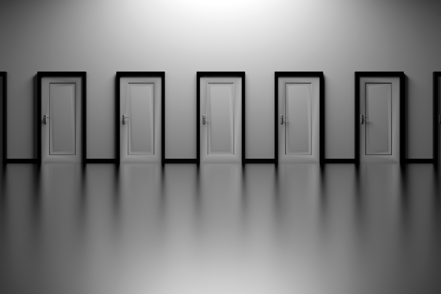 Black-and-white minimalist image of a row of closed doors reflected in a polished floor.