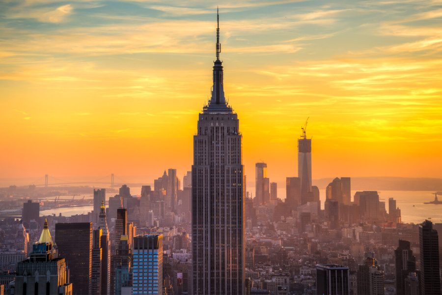 New York City skyline with the Empire State Building against a golden sunrise sky
