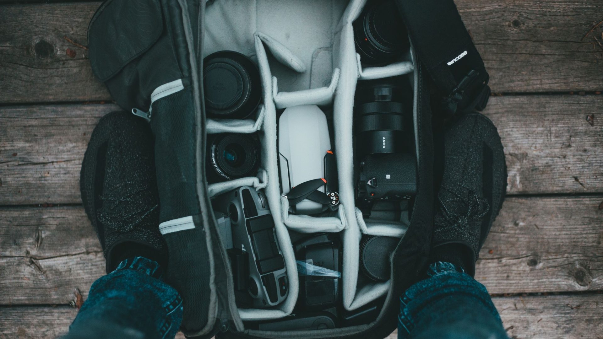 Camera bodies and lenses organized in a padded photography backpack