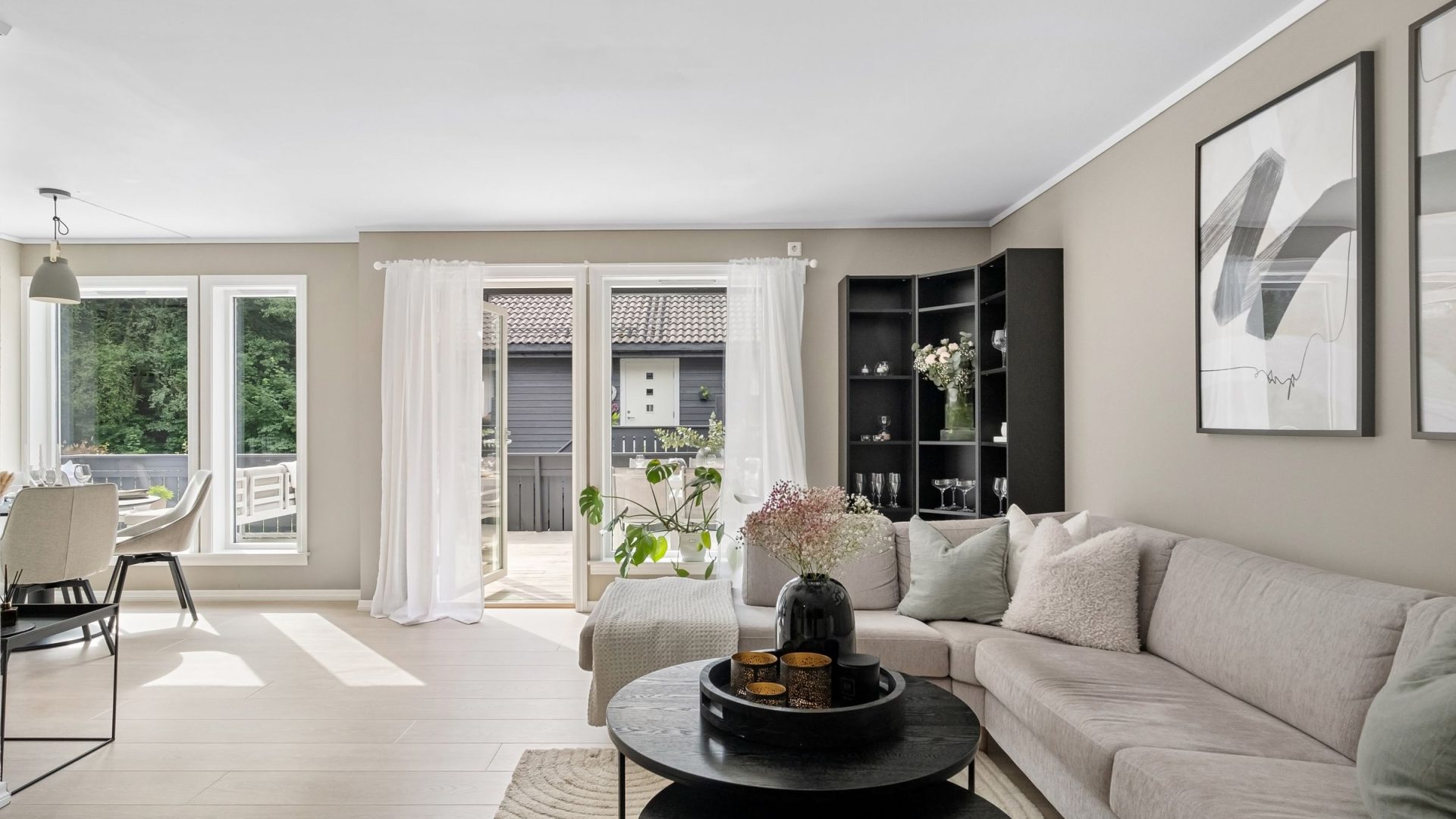 Bright living room with a pale sofa and terrace doors letting in daylight