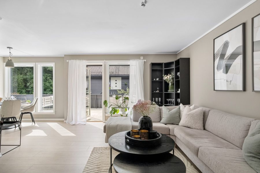 Bright living room with a pale sofa and terrace doors letting in daylight