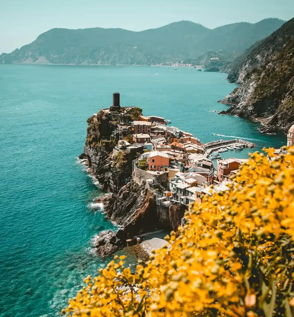 Colorful cliffside village on the Italian Riviera with a small harbor and turquoise sea