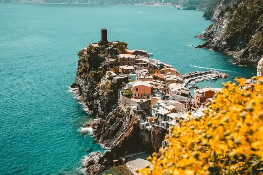Colorful cliffside village on the Italian Riviera with a small harbor and turquoise sea