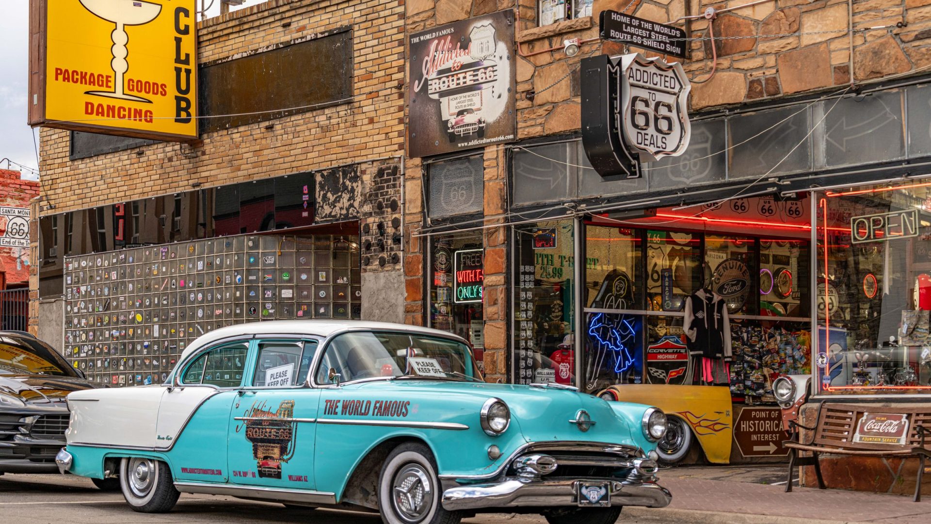 Turquoise vintage car parked outside a Route 66 storefront in Williams, Arizona.