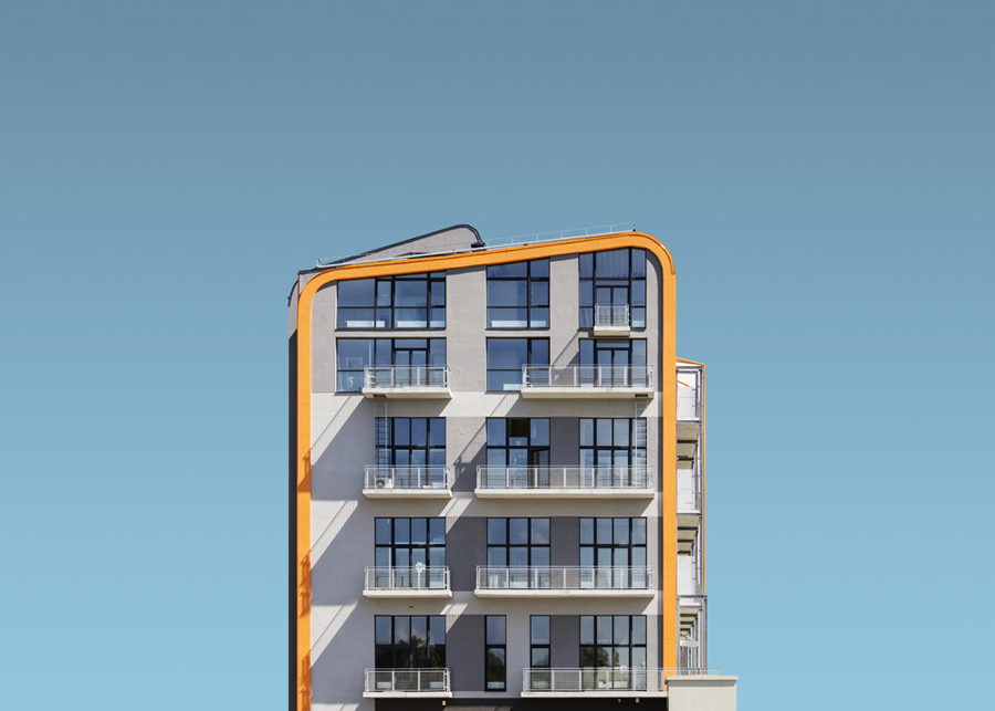 Balconied building against pale blue sky