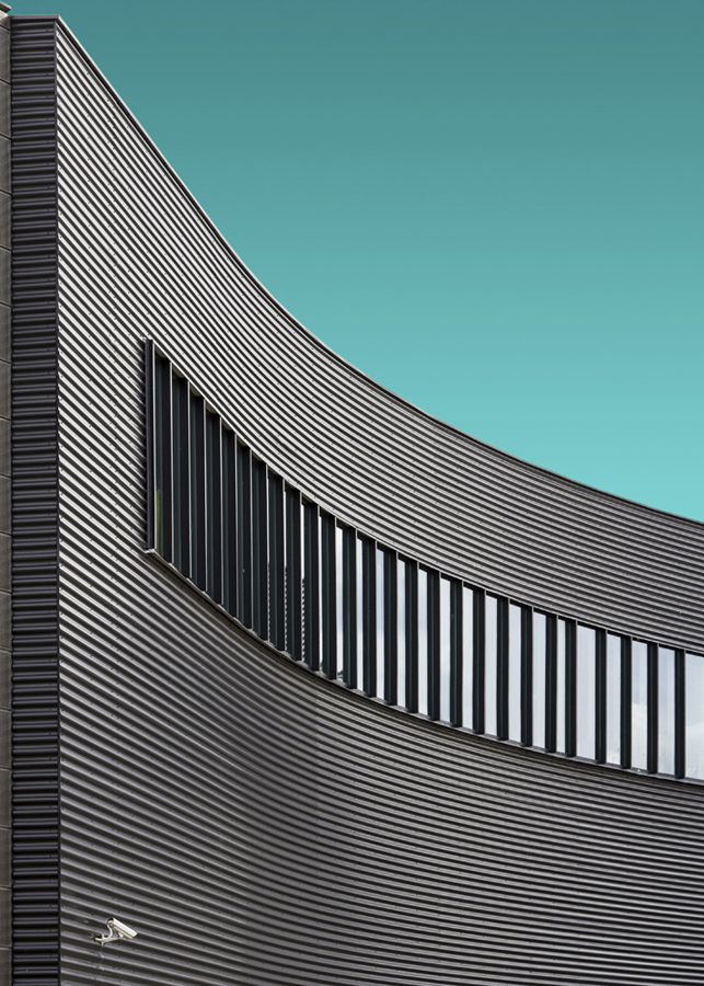 Curved building facade and sky