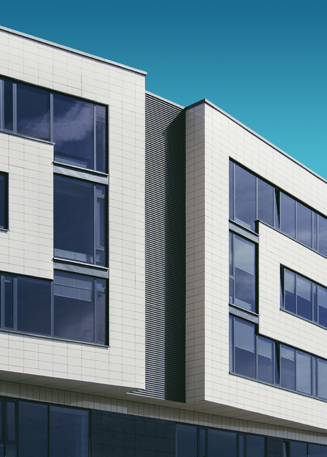 Minimalist white building with dark windows