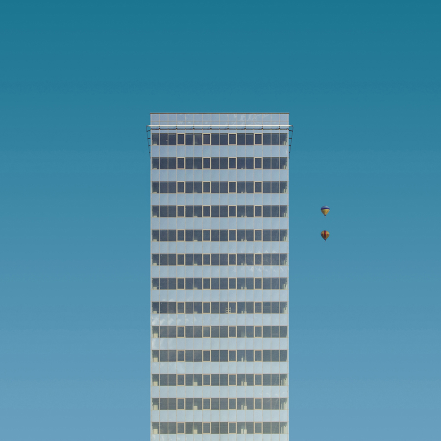 Single high-rise building framed by blue sky