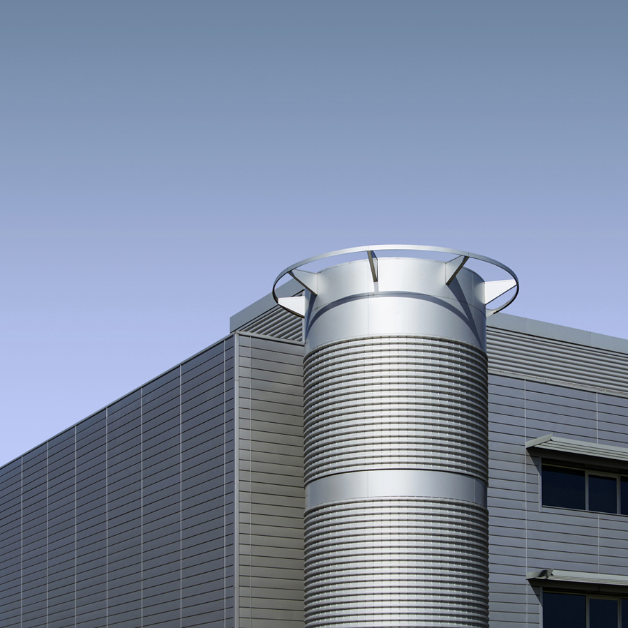 Metallic cylindrical tower beside a building