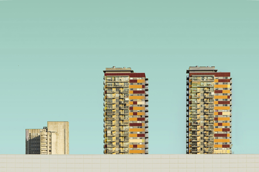 Twin apartment towers against a blue sky