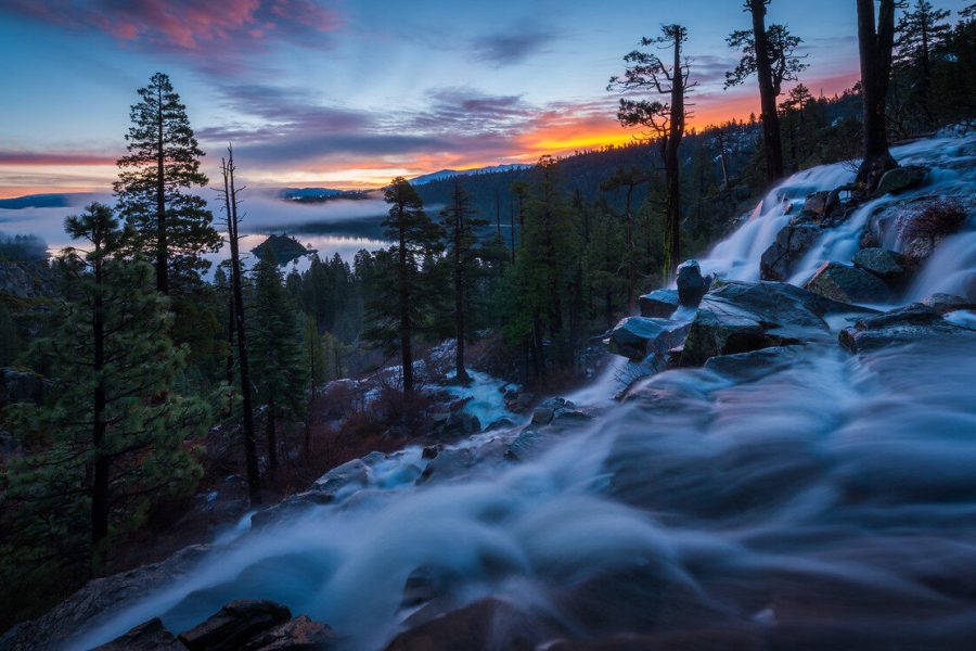 Long-exposure waterfall above Lake Tahoe beneath a pink-blue sky
