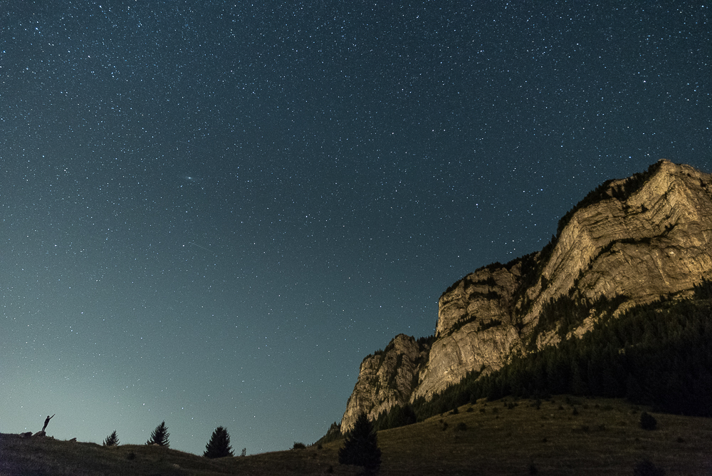 Rocky mountain outcrop under a clear night sky.