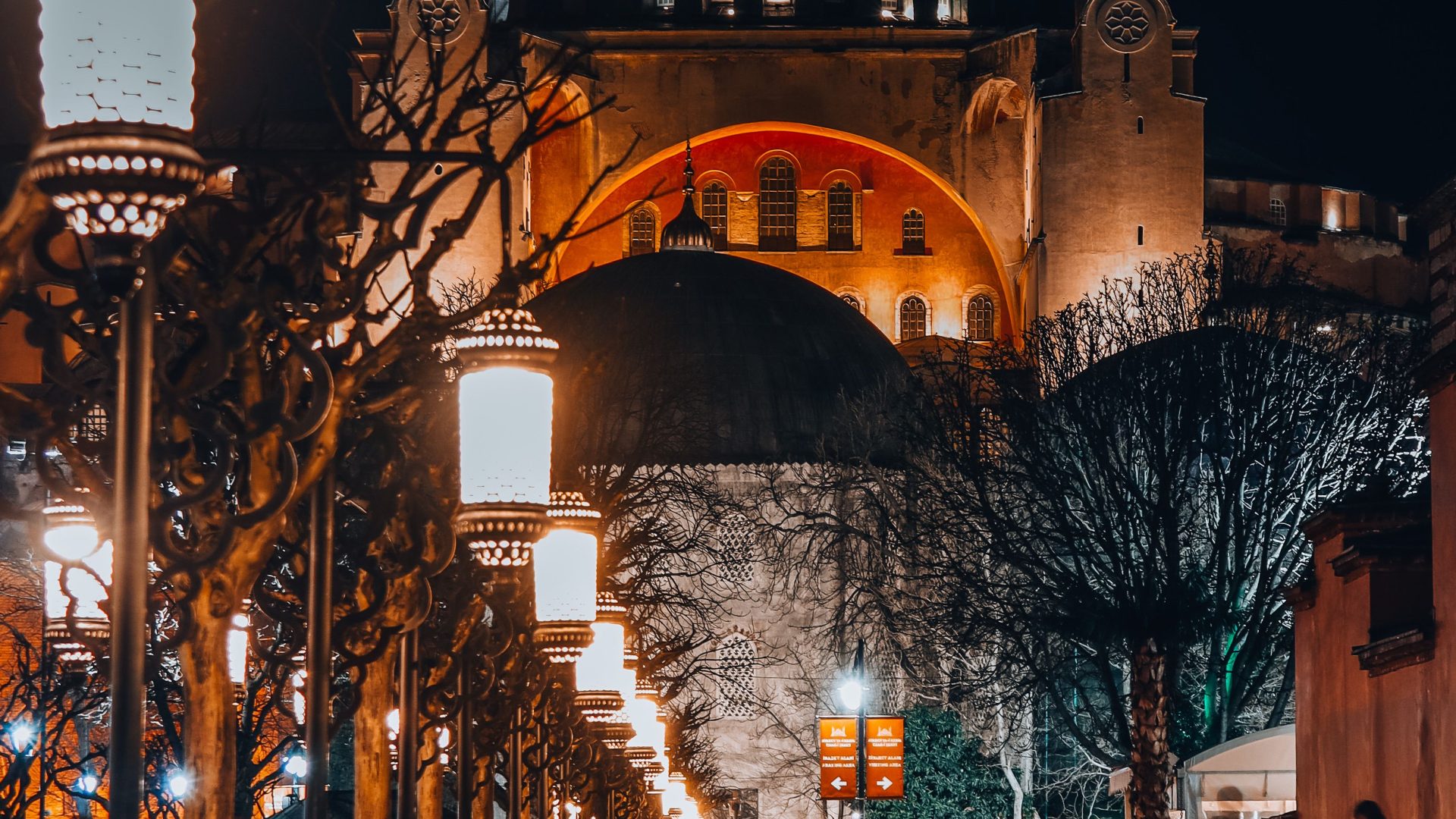Hagia Sophia in Istanbul at night beside a lantern-lined path