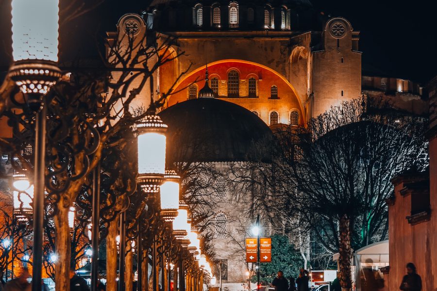 Hagia Sophia in Istanbul at night beside a lantern-lined path