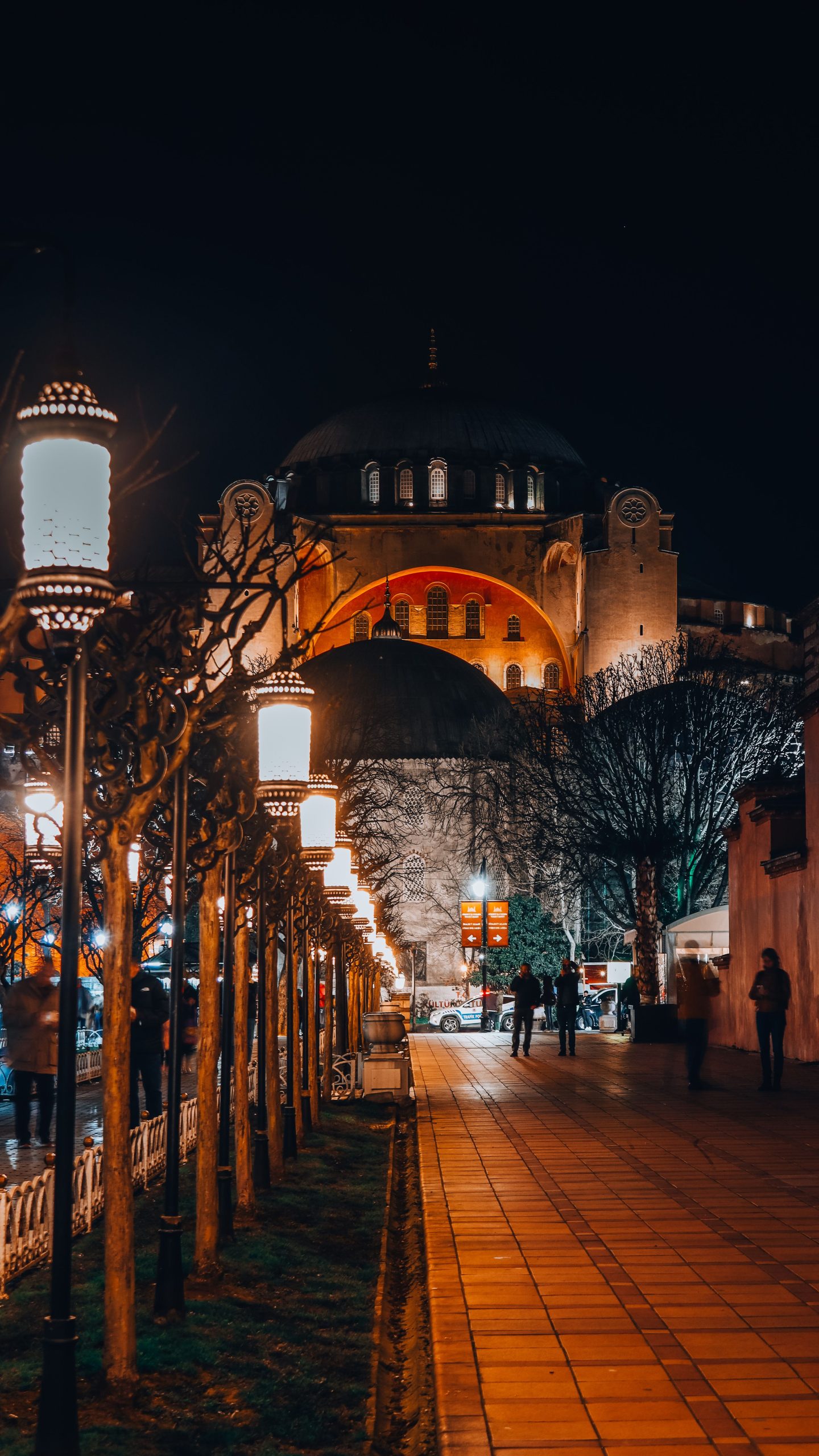 Hagia Sophia in Istanbul at night beside a lantern-lined path