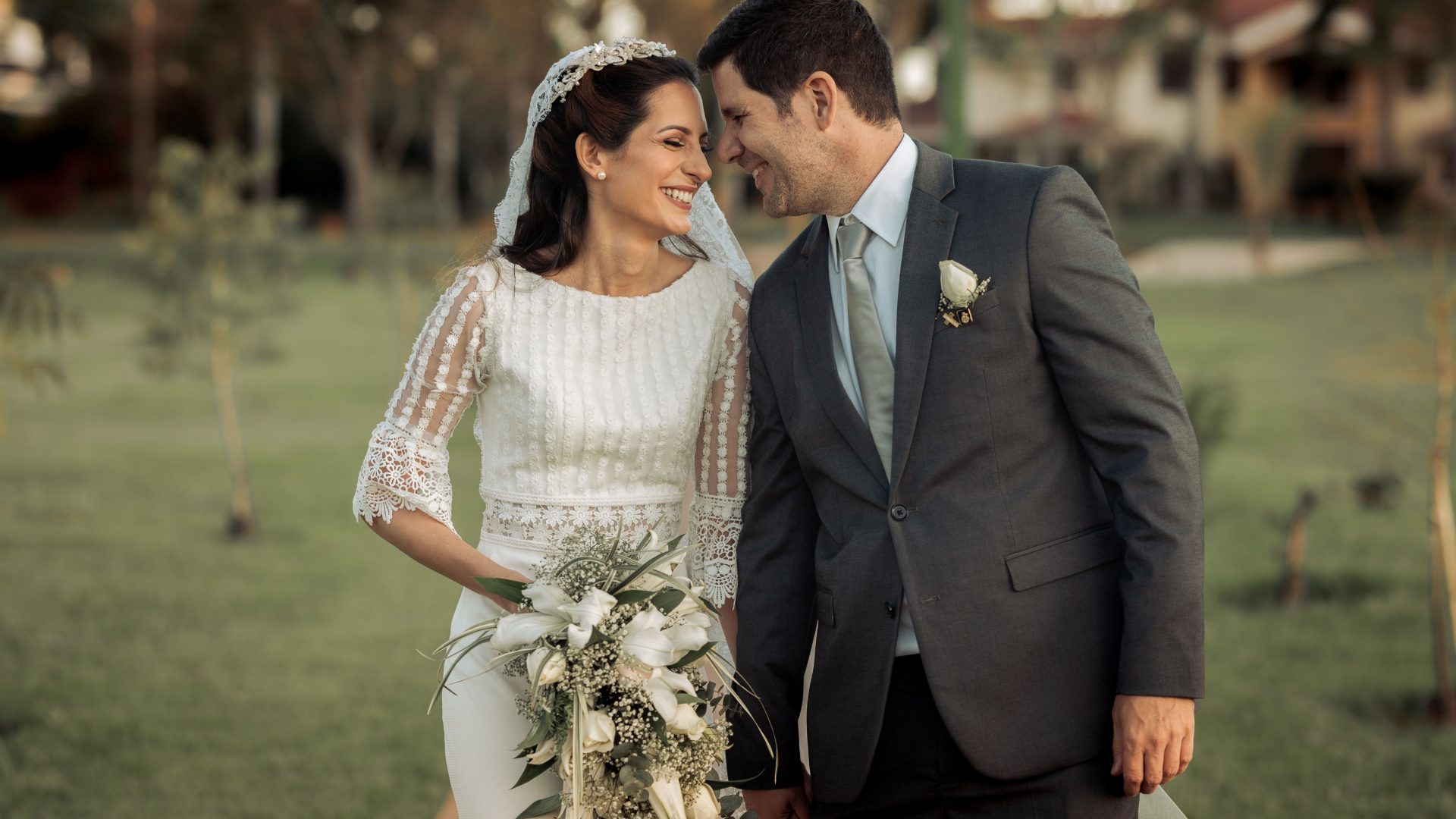 Bride and groom smiling together during an outdoor wedding portrait