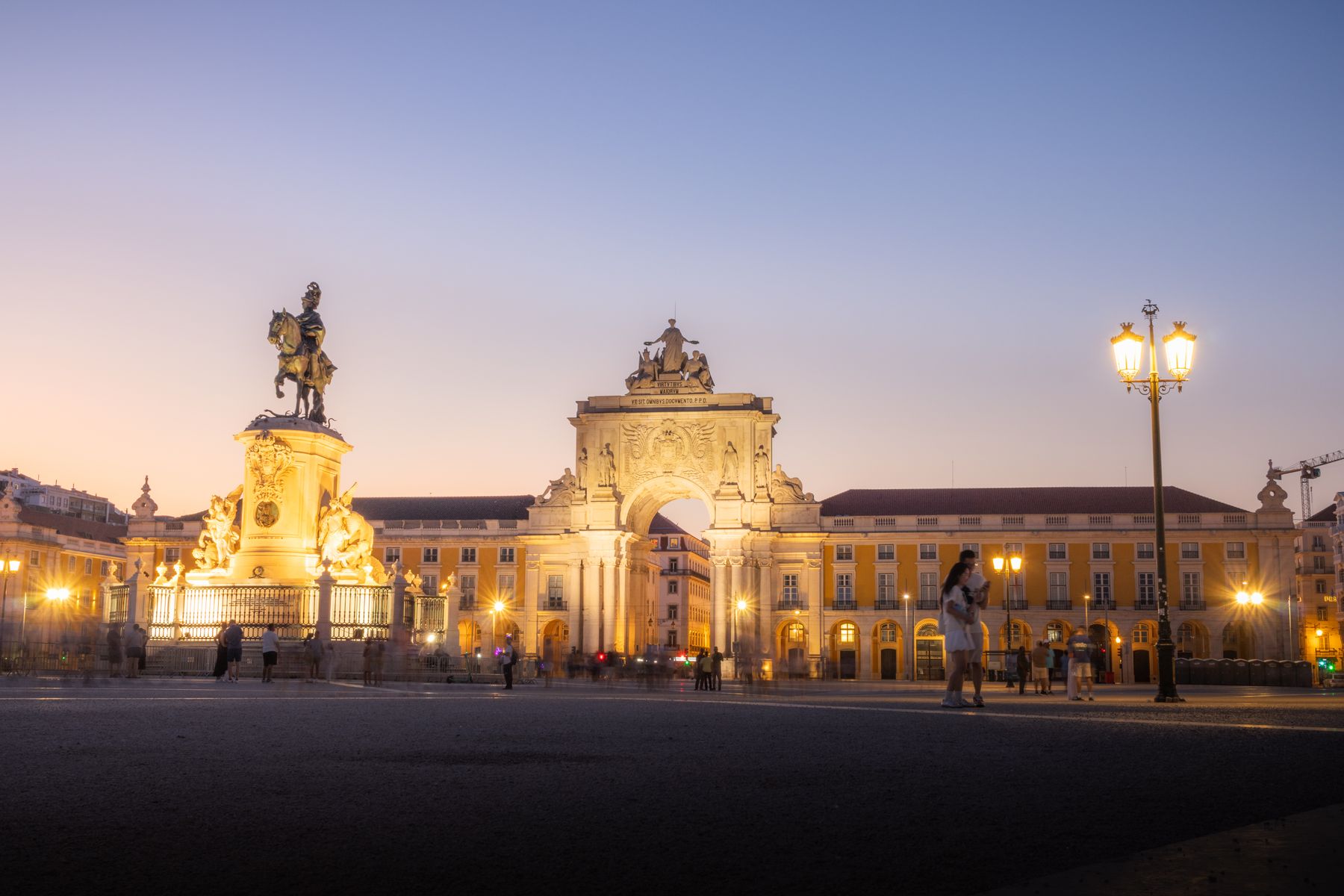 Praça do Comércio in Lisbon at twilight with the Rua Augusta Arch and a lit statue