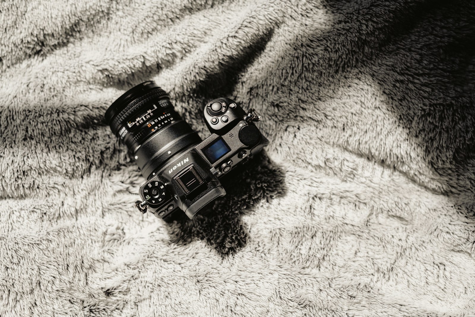 Nikon Z mirrorless camera body from above with an F-mount lens attached through an adapter