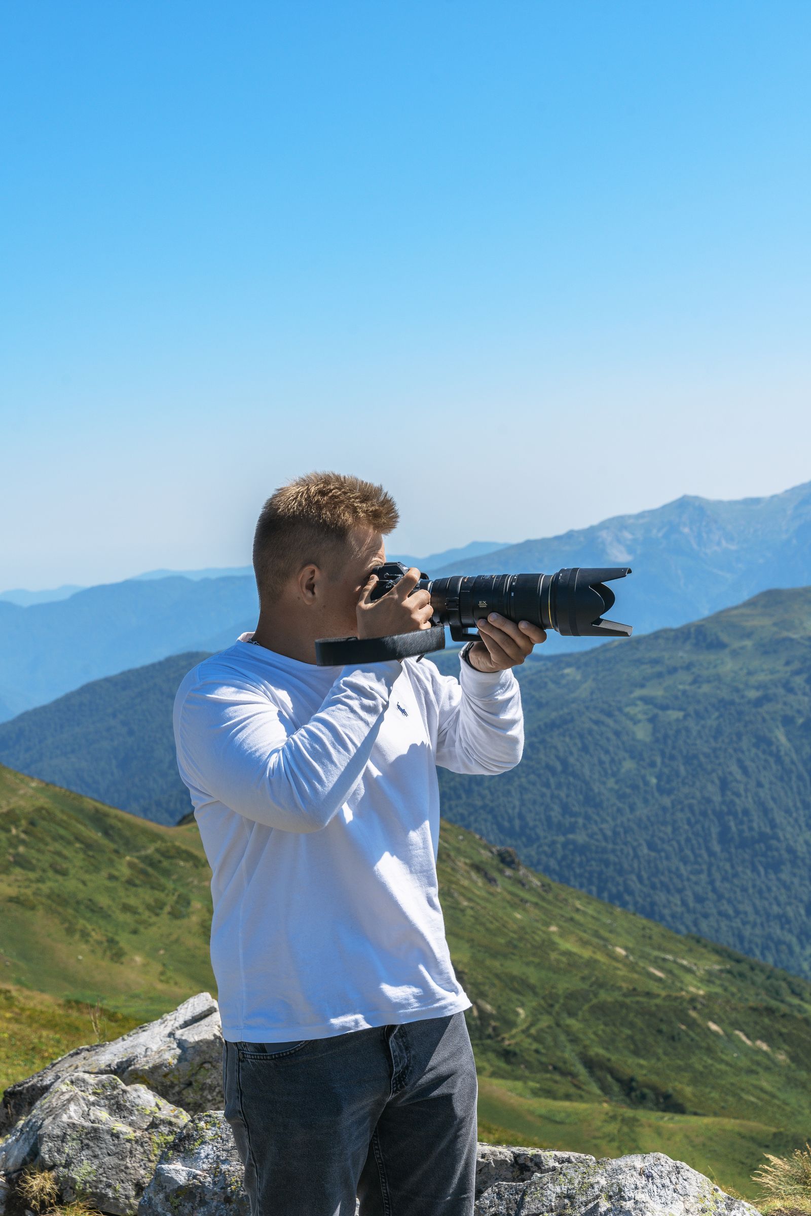 Photographer capturing a scenic mountain view