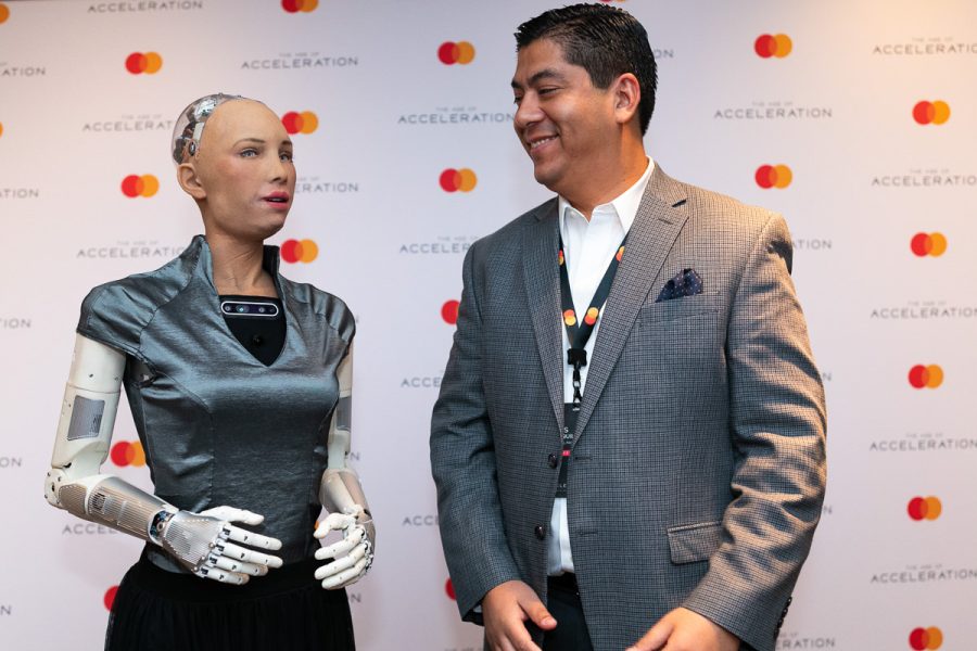 Man and humanoid robot photographed together at a conference