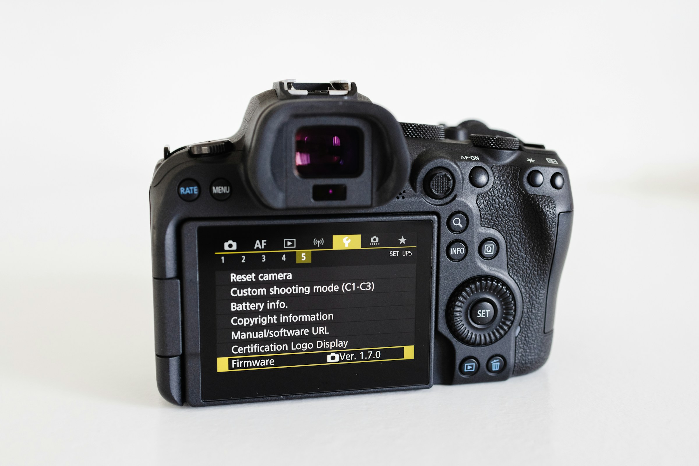 The back of a mirrorless camera showing its setup menu on a white surface