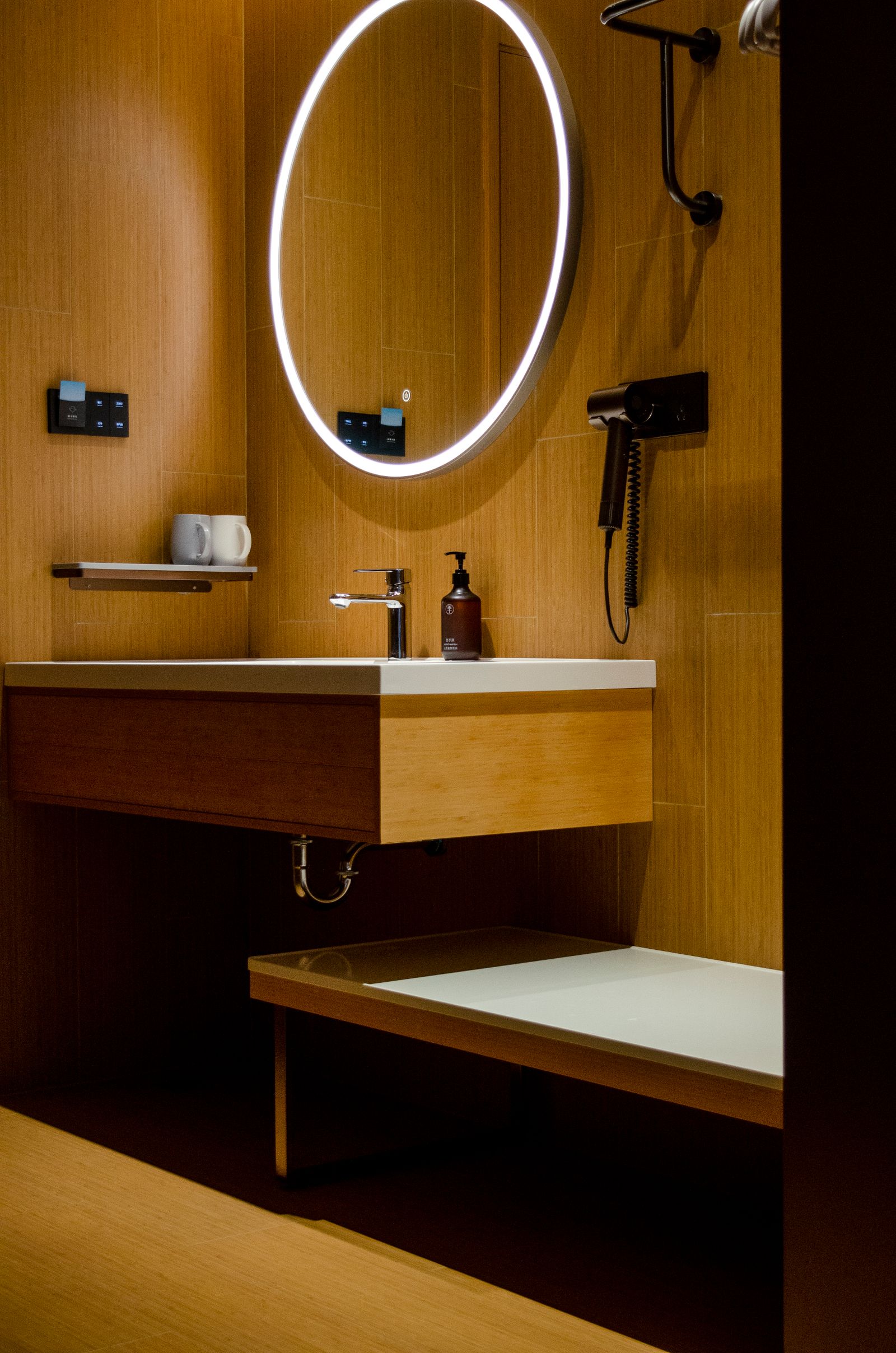 Luxury bathroom with illuminated mirror and warm wood tones
