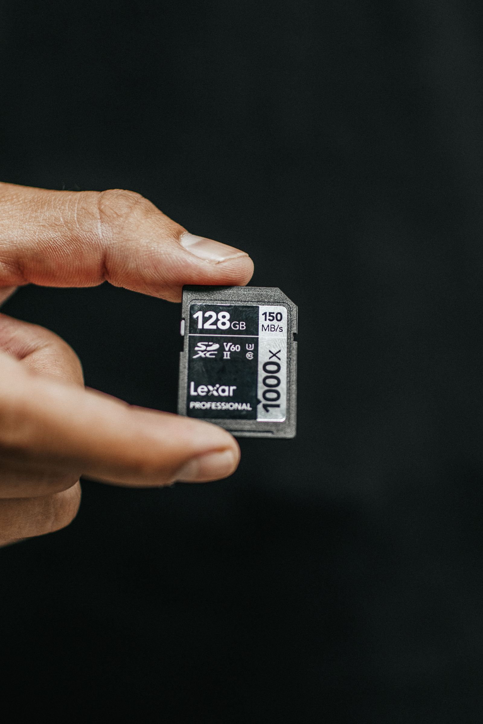 Person holding a 128GB SD card