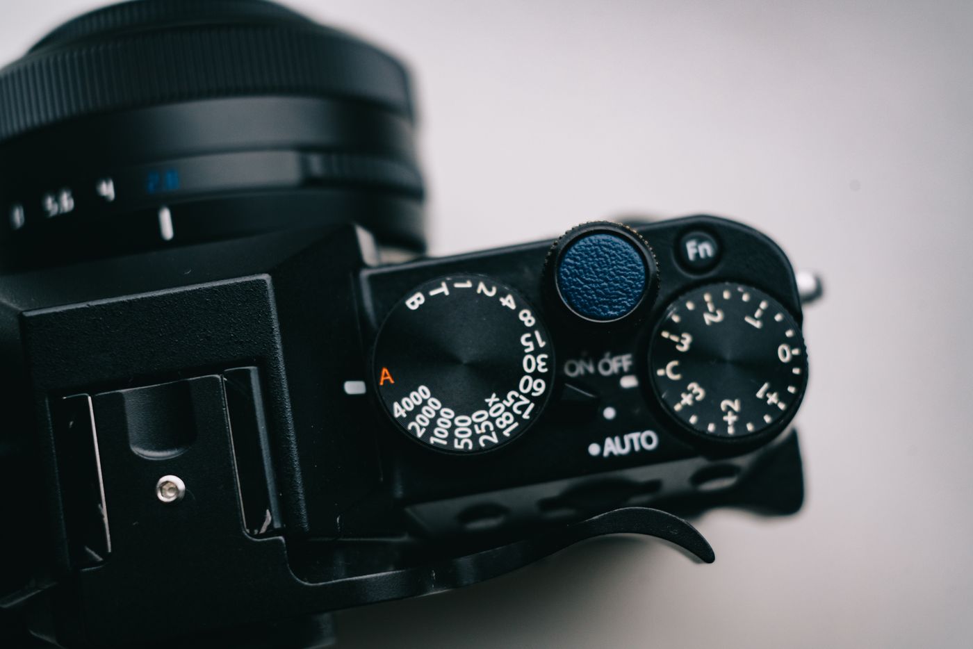 Close-up of a camera's mode dial, shutter speed dial and auto switch.