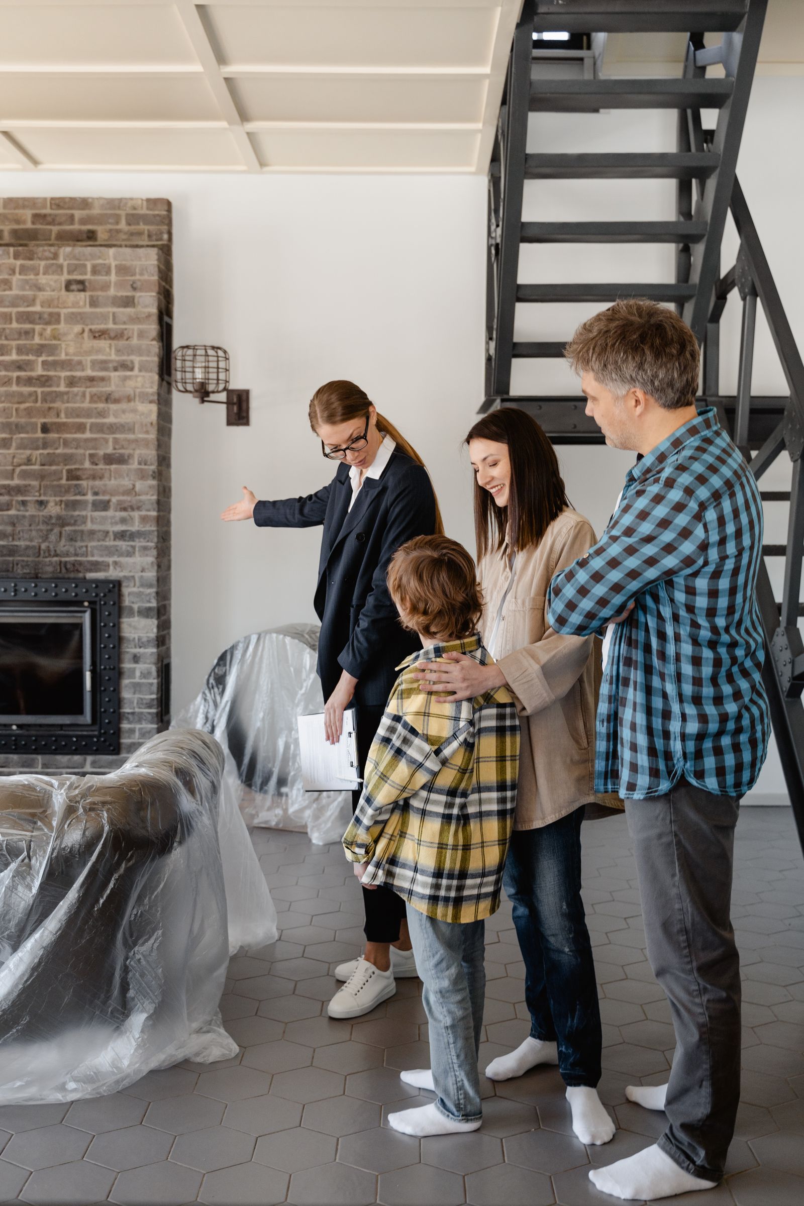 Agent showing a living room to clients during a viewing