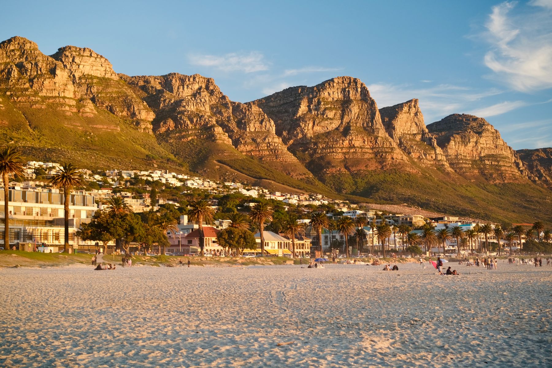 Camps Bay beach in warm evening light with the Twelve Apostles mountains behind