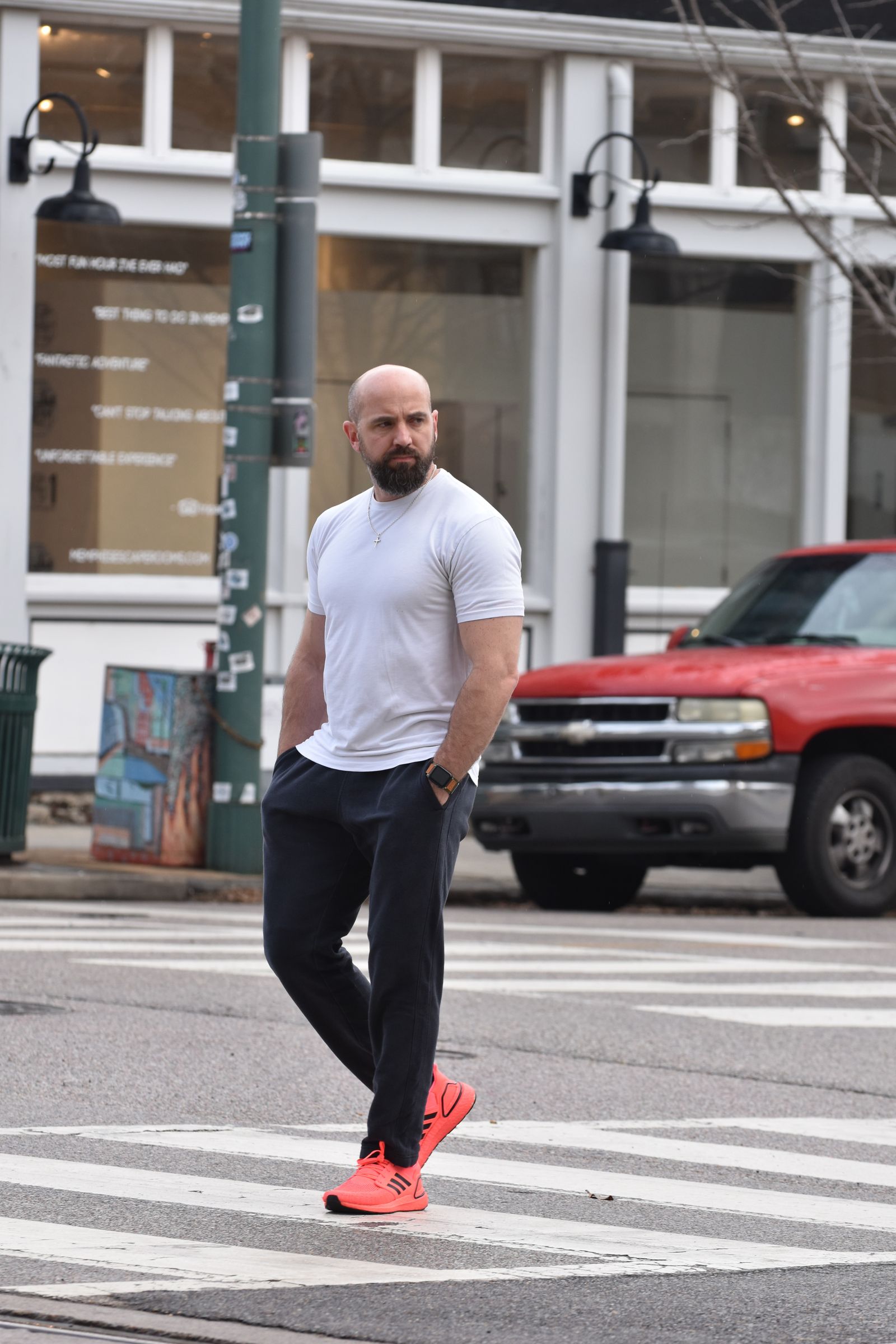 Pedestrian in bright red shoes walking across a city zebra crossing