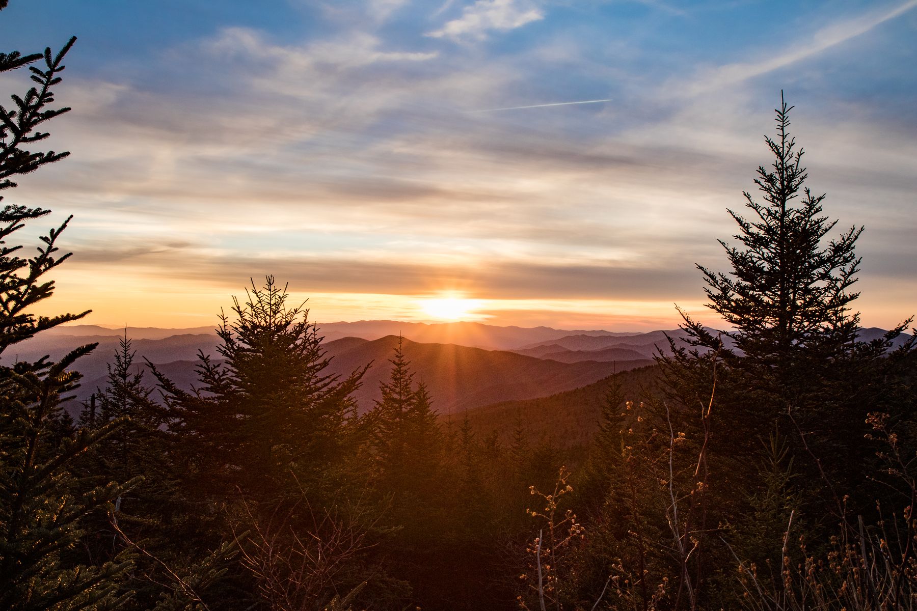 Sunstar sunset over layered ridges and spruce in the Great Smoky Mountains