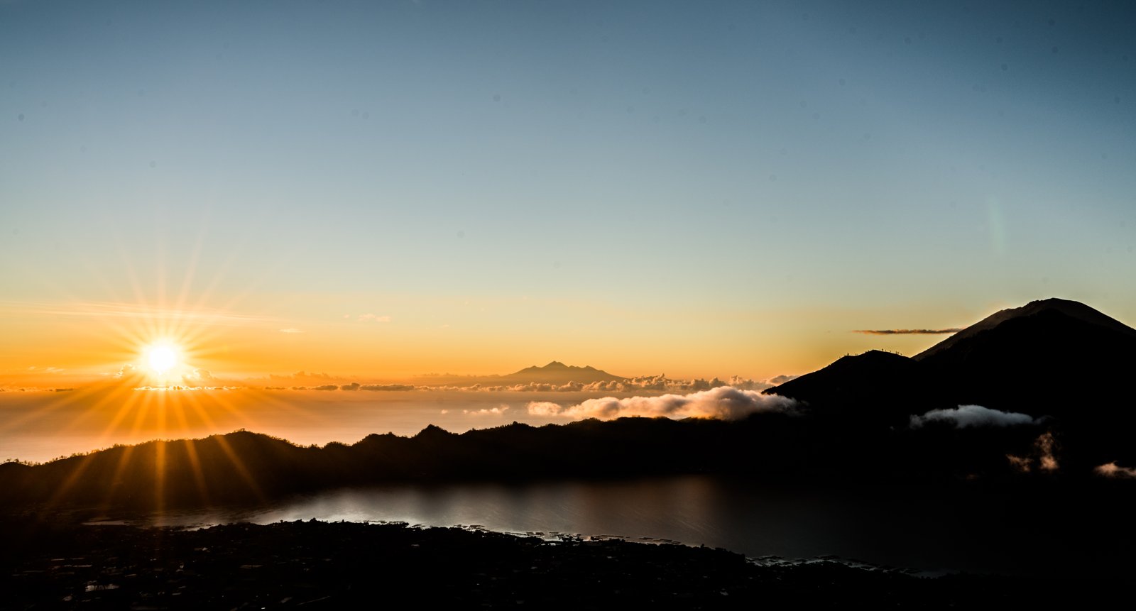 Sunrise from Mount Batur over Lake Batur with Mount Agung in the distance