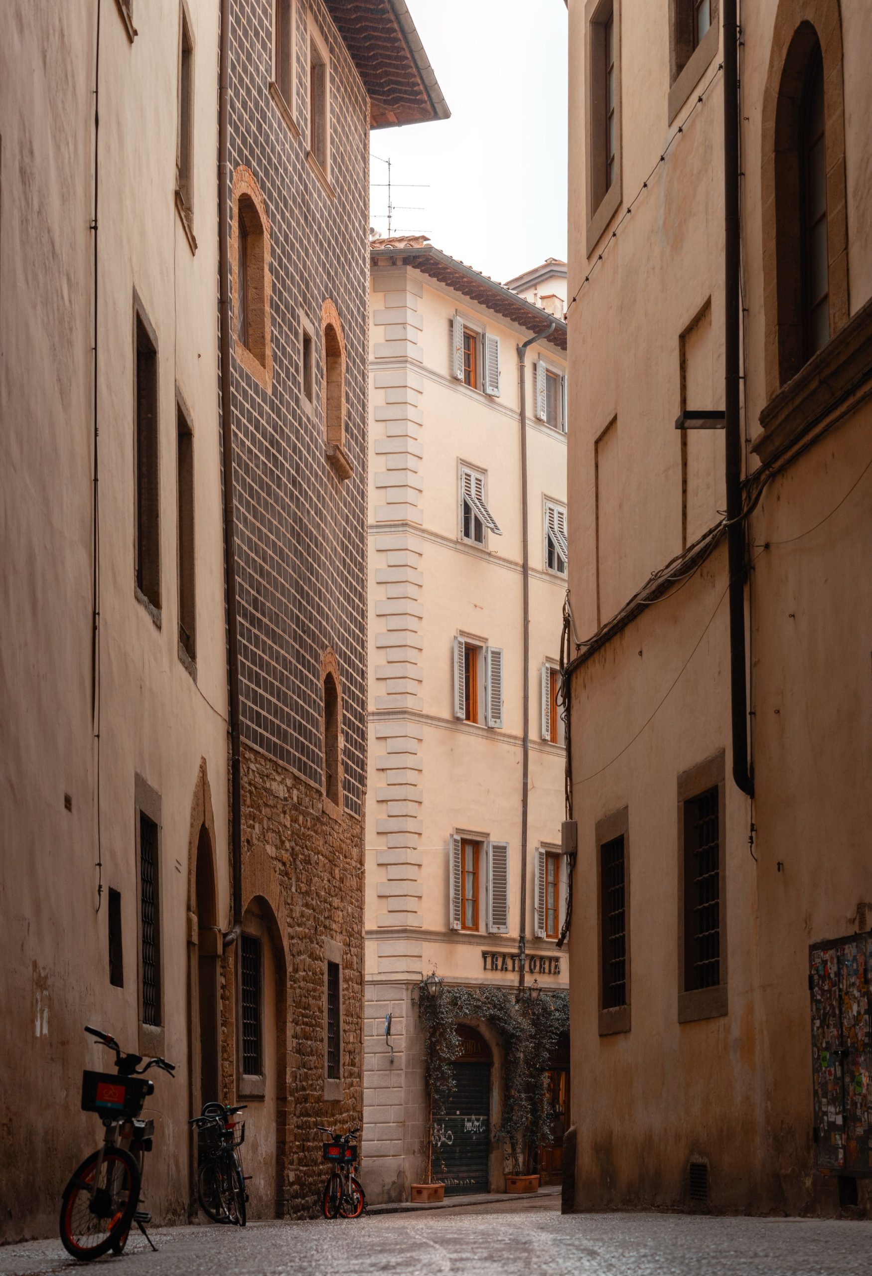 Bicycles and warm-toned walls along a Florence street