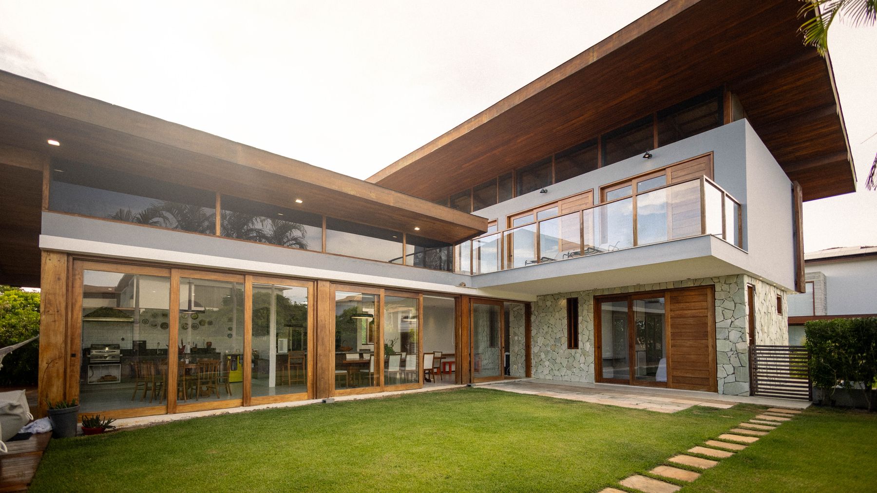 Contemporary house exterior combining timber cladding and floor-to-ceiling glass.