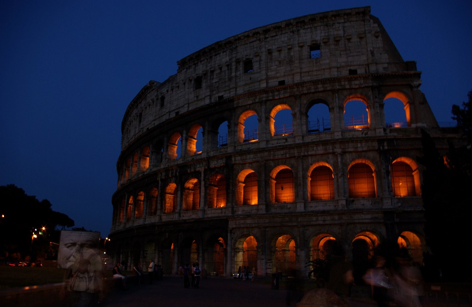 The Colosseum at blue hour with glowing arches against a dark sky