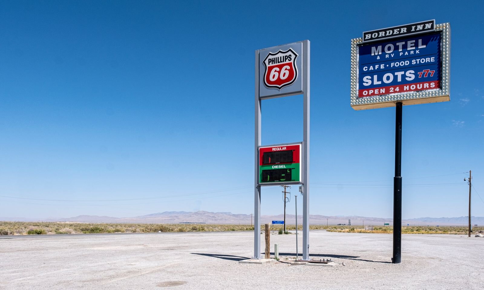Phillips 66 sign and a motel sign beside a gas station in the Mojave Desert along Route 66