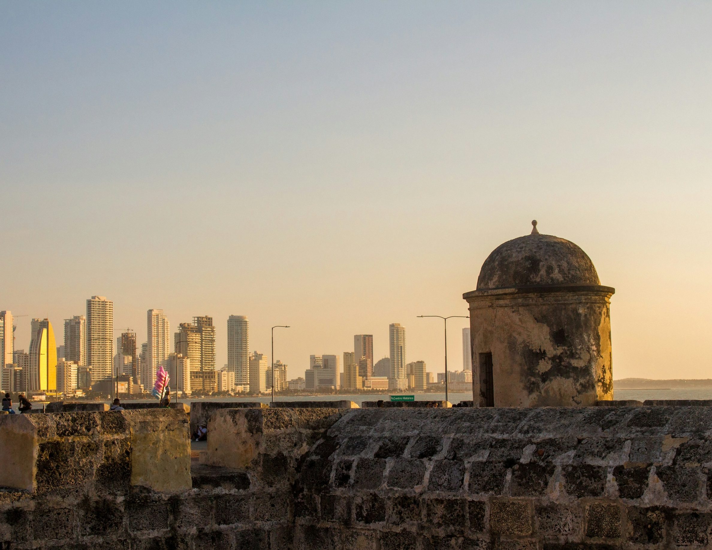 Warm light on Cartagena stone walls with buildings in the distance