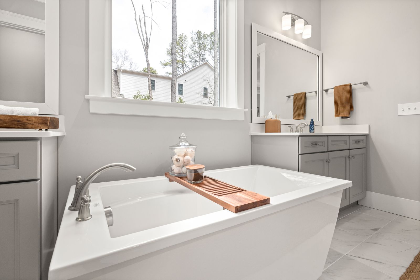 Bright bathroom with soaking tub and window light for a property listing