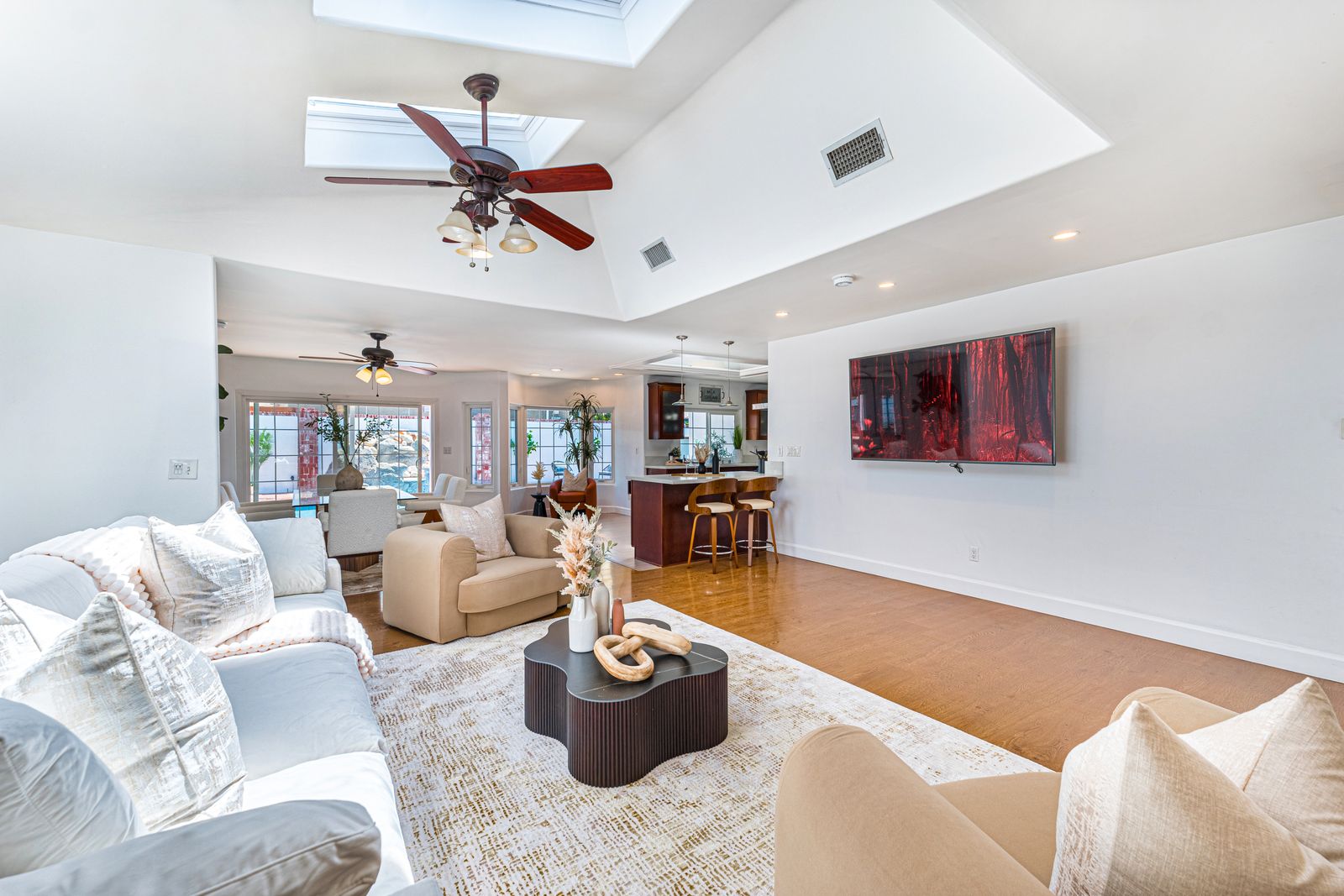 Bright open-plan living room with skylight and natural light for real estate photography