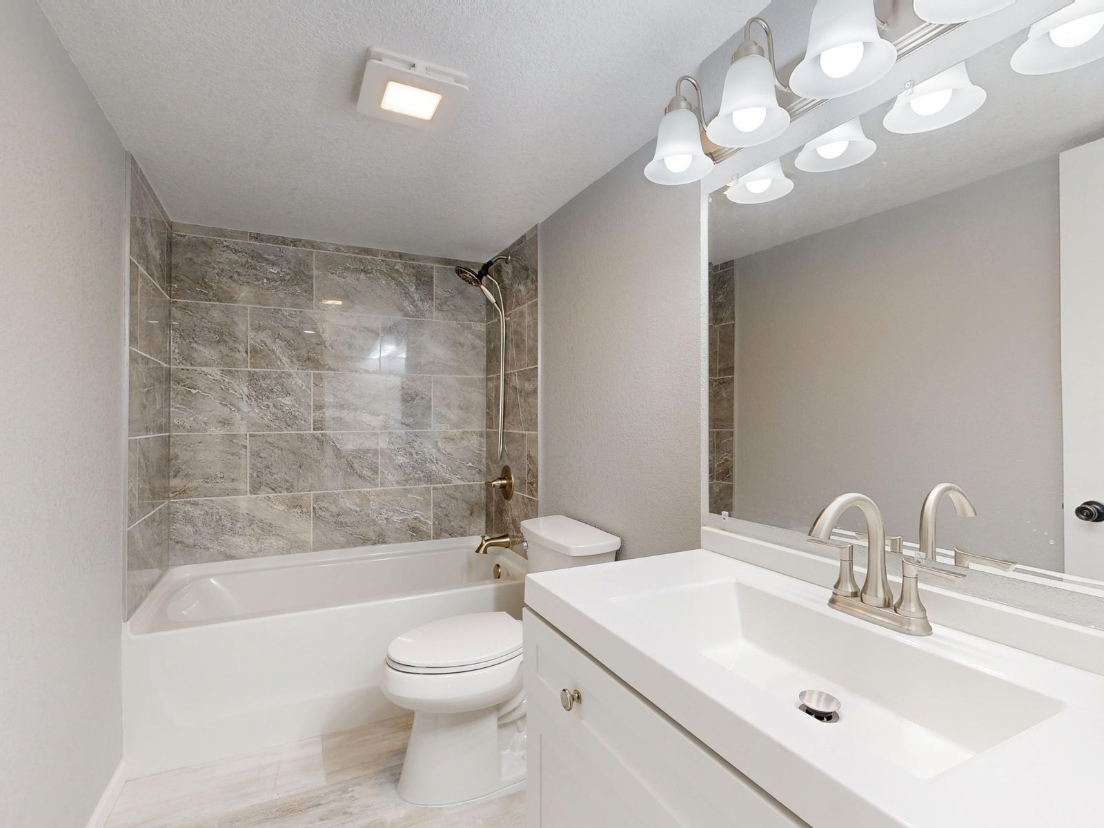 Bathroom with marble tile and vanity photographed for a listing
